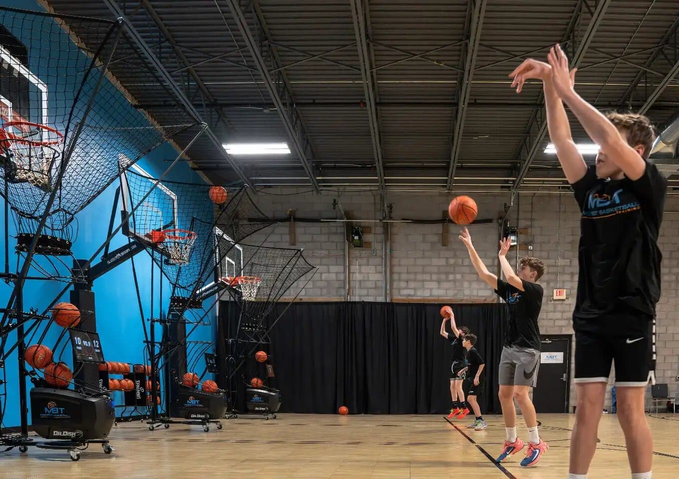 A multi-court training facility kitted out with a row of Dr. Dish shooting machines